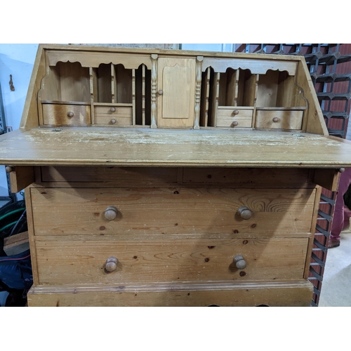 344 - Victorian pine bureau, fall flap revealing a fitted interior of pigeon holes and drawers over two sh... 