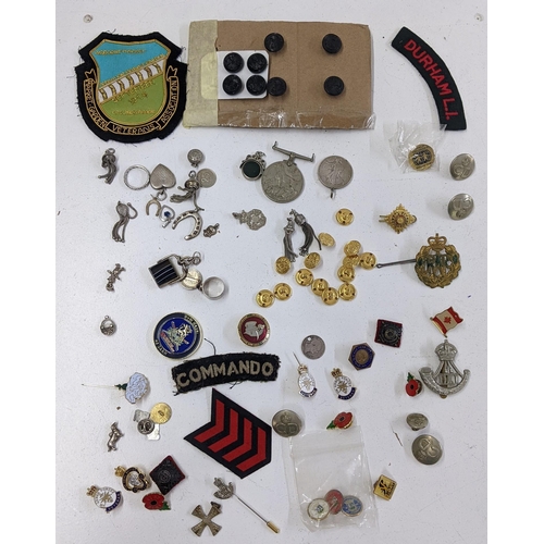 245 - A mixed lot of mainly badges to include a Durham Light Infantry cap badge, and others, together with... 