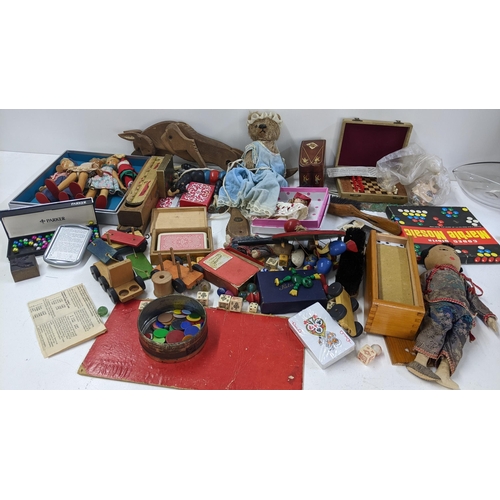 250 - A mixed lot to include playing cards, boxed miniature chess set, dolls and other various toys and ga... 