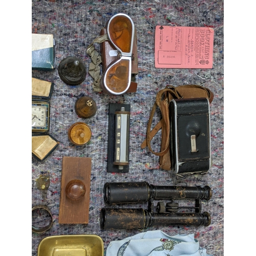 280 - A mixed lot consisting of binoculars, lighters, a mid century desk calendar, a brass candle/chamber ... 