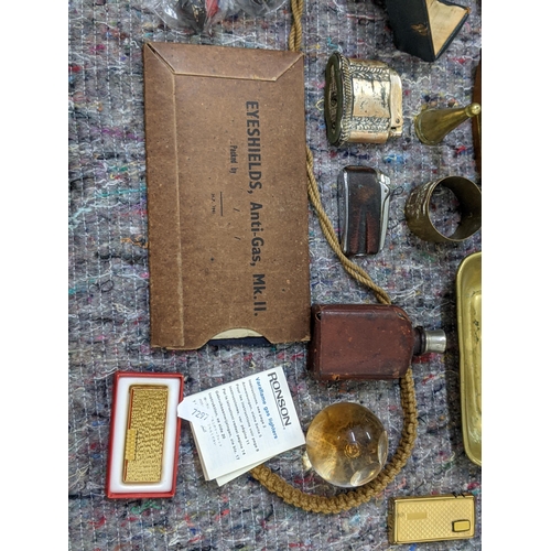 280 - A mixed lot consisting of binoculars, lighters, a mid century desk calendar, a brass candle/chamber ... 