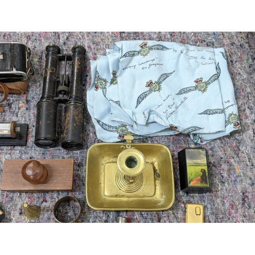 280 - A mixed lot consisting of binoculars, lighters, a mid century desk calendar, a brass candle/chamber ... 