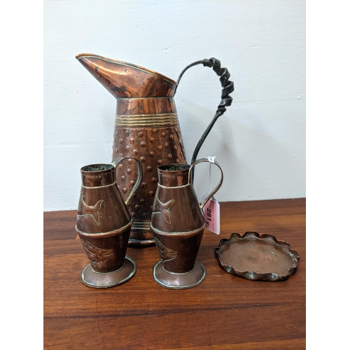 281 - Three copper jugs and a copper ashtray. The larger jug marked R. Perry & Sons, Wolverhampton, the sm... 