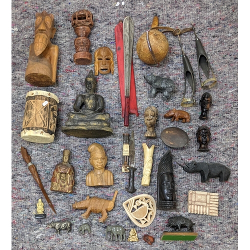 282 - A collection of African style wooden sculptures and figures to include a seated Buddha, a drum and o... 