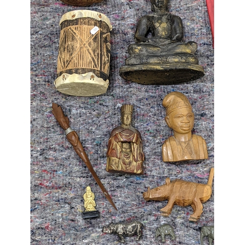 282 - A collection of African style wooden sculptures and figures to include a seated Buddha, a drum and o... 