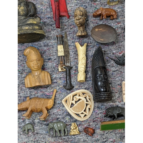 282 - A collection of African style wooden sculptures and figures to include a seated Buddha, a drum and o... 