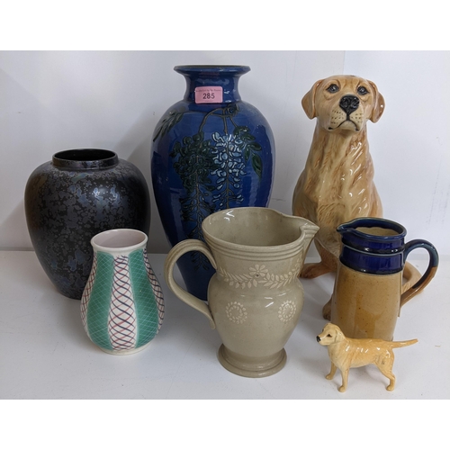 285 - China to include two, Royal Doulton jugs, two Poole pottery vases a large model of a golden retrieve... 