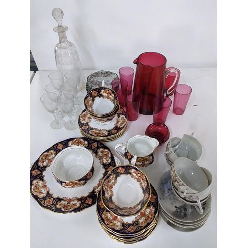 306 - Ceramics and glassware to include a Cranberry jug and beakers, a tea set, a Japanese tea set and oth... 