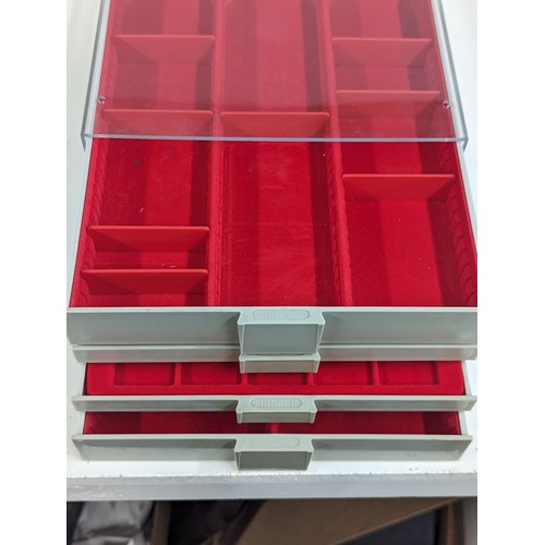 225 - A Lindner Coin/Collectors stackable trays, housing various sized red felt lined inserts,
Location: 8... 