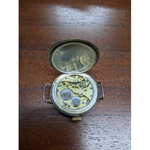 219 - An early 20th century metal cased The Glow Worm pocket watch, white enamel dial with Arabic numerals... 