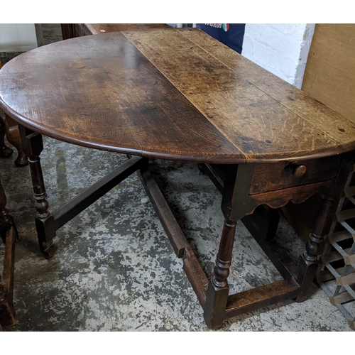 300 - An early 18th century oak drop leaf dining table on turned block legs Location: BWR