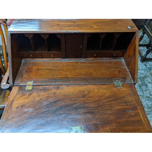 367 - A Georgian mahogany bureau, fall flap revealing a pigeonhole and drawer interior, short drawer over ... 