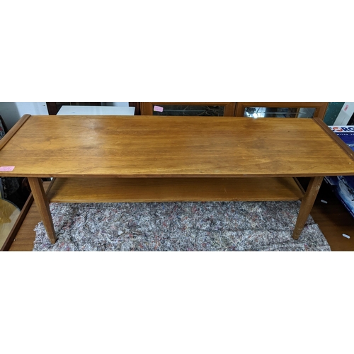 519 - A mid-century teak coffee table with undertier, a teak telephone seat with drawer, open shelves, and... 