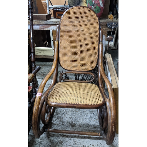 355 - An early 20th century Thonet style bentwood and cane rocking chair, incised stamped '18' to base edg... 