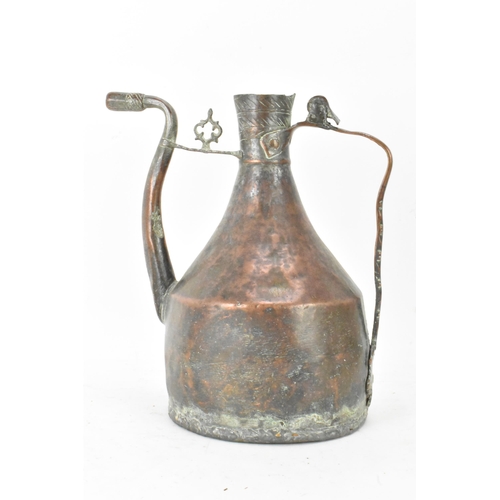 103 - A late 19th/early 20th century Islamic handmade copper water jug, the top having incised repeated de... 