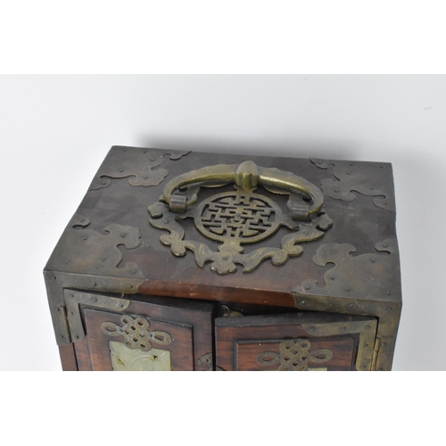 11 - A Chinese 20th century hardwood and jade panelled jewellery cabinet box, the cabinet having twin doo... 