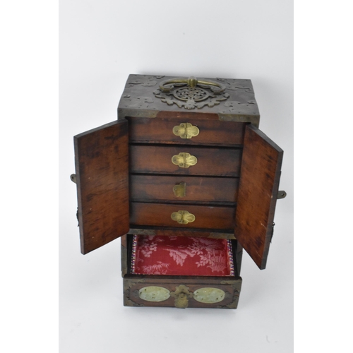 11 - A Chinese 20th century hardwood and jade panelled jewellery cabinet box, the cabinet having twin doo... 