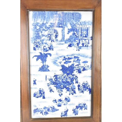 113 - A mid 20th century Chinese blue and white porcelain panel depicting scenes of children at play among... 