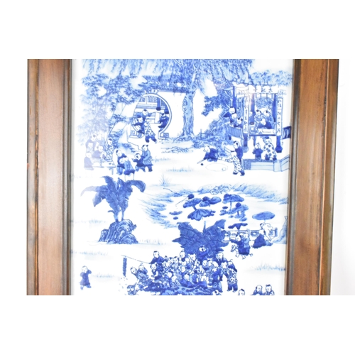 113 - A mid 20th century Chinese blue and white porcelain panel depicting scenes of children at play among... 