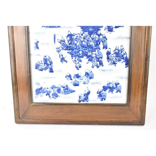 113 - A mid 20th century Chinese blue and white porcelain panel depicting scenes of children at play among... 