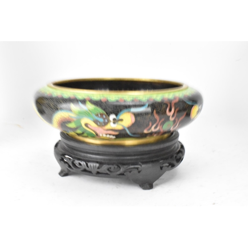 116 - A pair of Chinese mid 20th century cloisonne vases and a bowl, all with black grounds decorated with... 