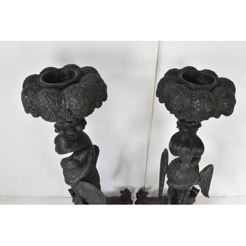 117 - A pair of late 19th century Anglo-Indian colonial ebonized carved plant stands, each having ornately... 