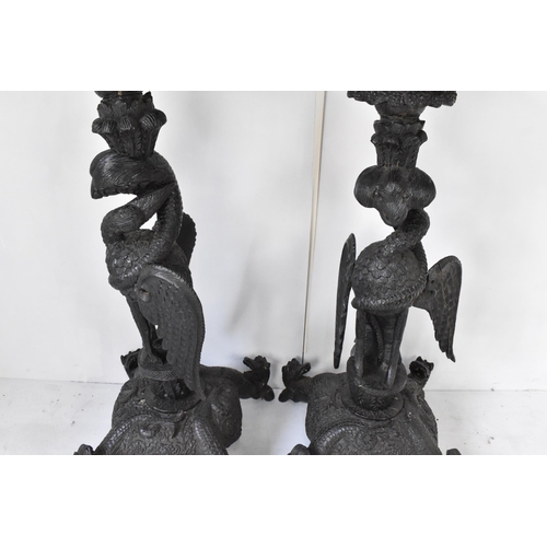 117 - A pair of late 19th century Anglo-Indian colonial ebonized carved plant stands, each having ornately... 