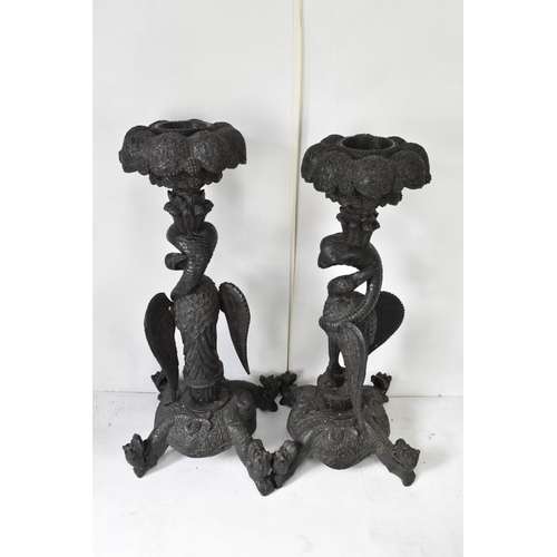 117 - A pair of late 19th century Anglo-Indian colonial ebonized carved plant stands, each having ornately... 