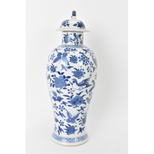 12 - A Chinese Qing dynasty blue and white lidded vase, late 19th/early 20th century, decorated with bird... 