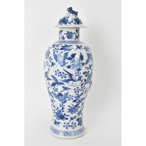 12 - A Chinese Qing dynasty blue and white lidded vase, late 19th/early 20th century, decorated with bird... 