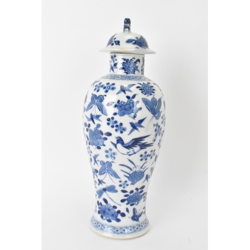 12 - A Chinese Qing dynasty blue and white lidded vase, late 19th/early 20th century, decorated with bird... 