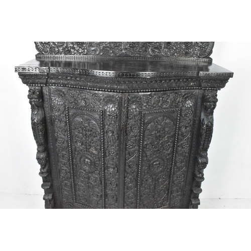 120 - A 19th century Anglo Indian colonial black lacquered hardwood cabinet, serpentine fronted and profus... 