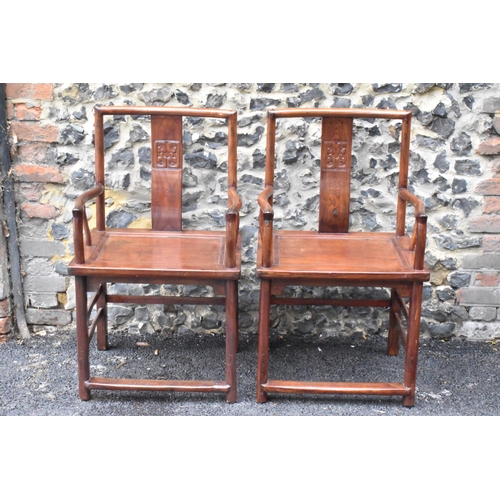 122 - A pair of 20th century Chinese Ming style hardwood armchairs, with curved top rail and curved centra... 