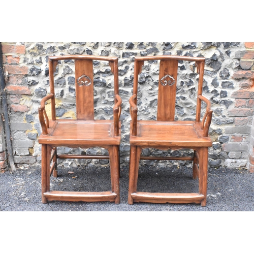 123 - A pair of 20th century Chinese Ming style hardwood armchairs, with curved top rail and curved centra... 