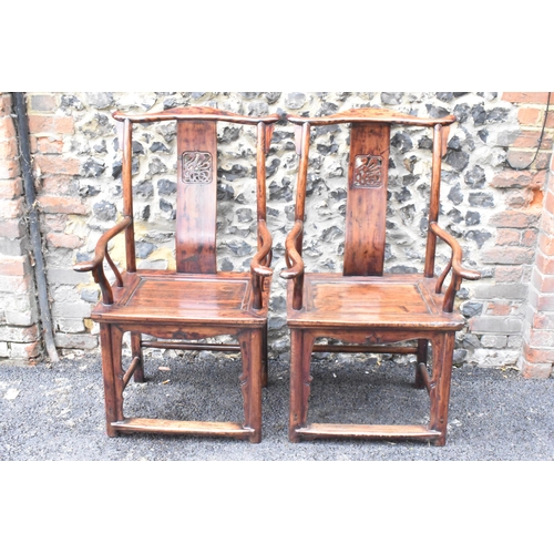 124 - A pair of 20th century Chinese Ming style yoke back hardwood armchairs, with curved top rail and cur... 