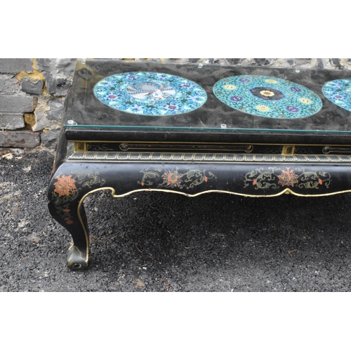 125 - A Chinese 20th century cloisonne coffee table, the black  lacquered low coffee table with a rectangu... 