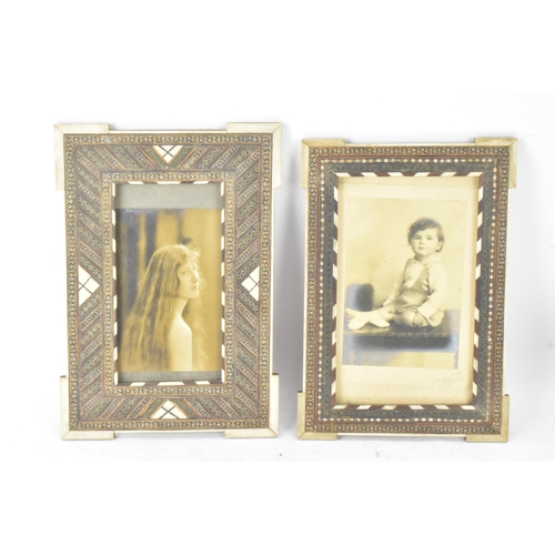 126 - Two similar Persian late Qajar dynasty photograph frames, the profusely inlaid frames having multi g... 