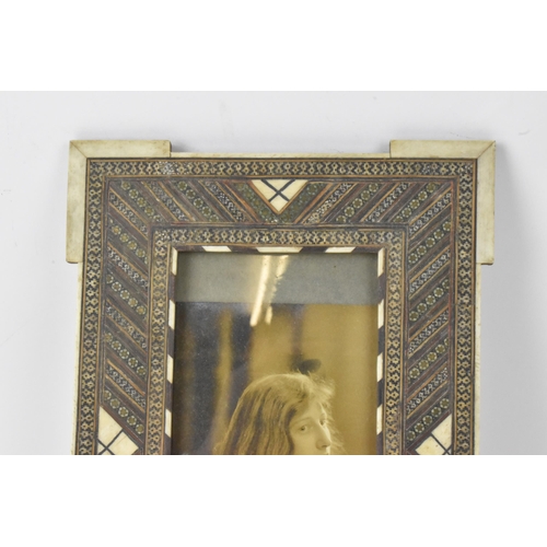 126 - Two similar Persian late Qajar dynasty photograph frames, the profusely inlaid frames having multi g... 