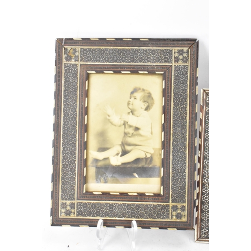 127 - Three similar Persian late Qajar dynasty photograph frames, the profusely inlaid frames having micro... 