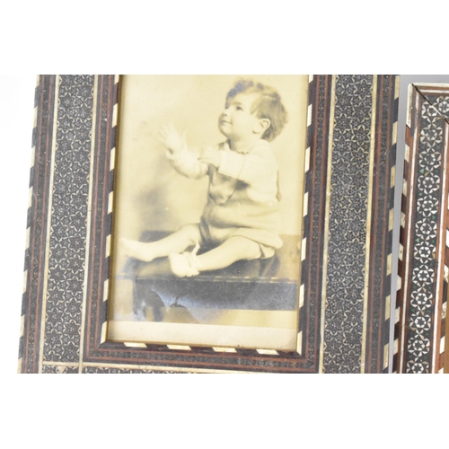 127 - Three similar Persian late Qajar dynasty photograph frames, the profusely inlaid frames having micro... 