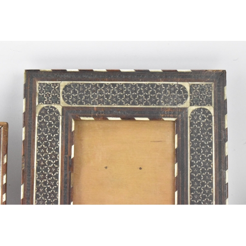 127 - Three similar Persian late Qajar dynasty photograph frames, the profusely inlaid frames having micro... 