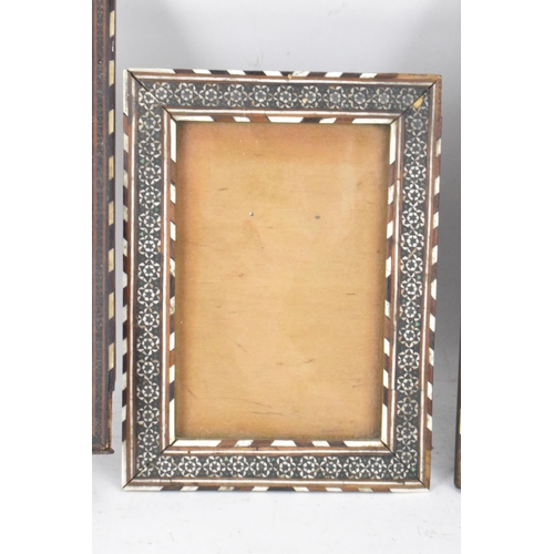 127 - Three similar Persian late Qajar dynasty photograph frames, the profusely inlaid frames having micro... 