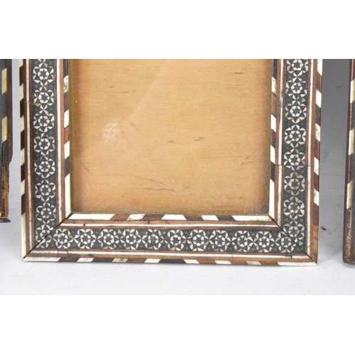 127 - Three similar Persian late Qajar dynasty photograph frames, the profusely inlaid frames having micro... 