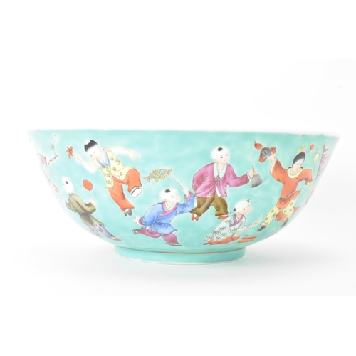 13 - A Chinese Famille Rose porcelain bowl, on a turquoise ground and decorated in various enamels depict... 