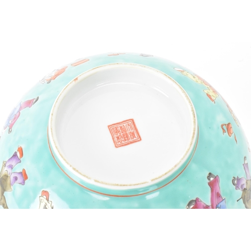 13 - A Chinese Famille Rose porcelain bowl, on a turquoise ground and decorated in various enamels depict... 