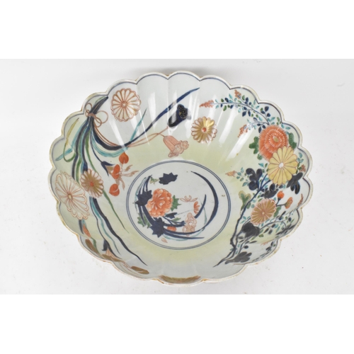 130 - A Japanese Edo period Arita Imari porcelain punch bowl, circa 1700, having a shaped rim and fluted b... 