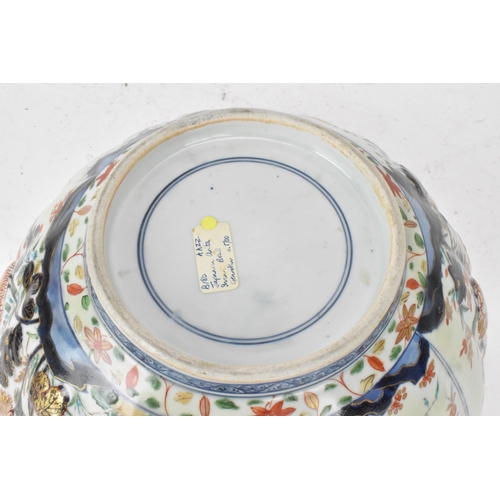 130 - A Japanese Edo period Arita Imari porcelain punch bowl, circa 1700, having a shaped rim and fluted b... 