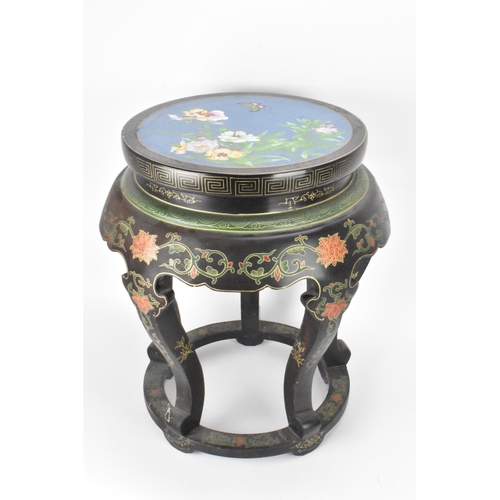 131 - A Chinese 20th century occasional table, having a black lacquered frame supported by five curved cab... 