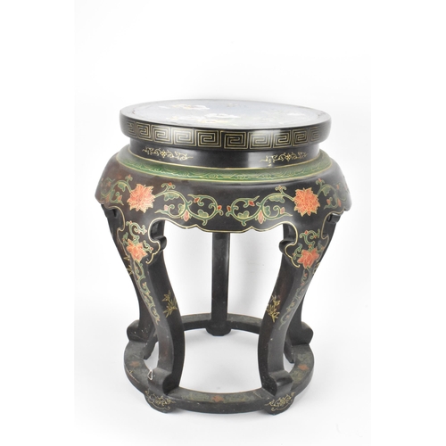 131 - A Chinese 20th century occasional table, having a black lacquered frame supported by five curved cab... 