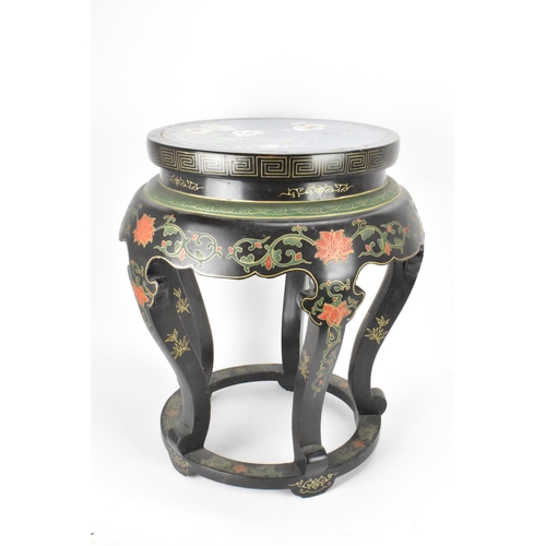 131 - A Chinese 20th century occasional table, having a black lacquered frame supported by five curved cab... 